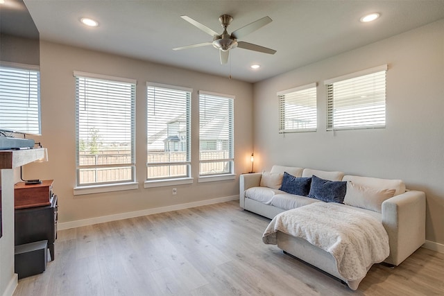 living room featuring light hardwood / wood-style floors and ceiling fan