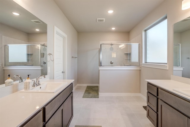 bathroom featuring vanity, walk in shower, and tile patterned flooring