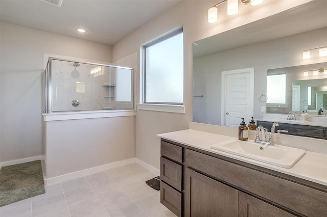 bathroom with vanity, walk in shower, and tile patterned floors