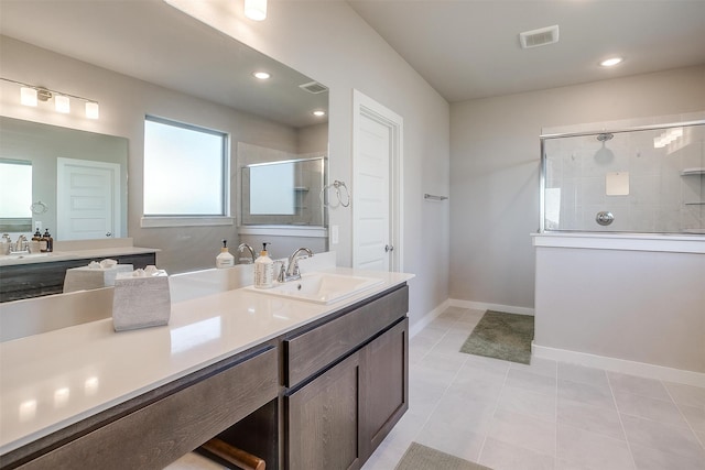 bathroom with vanity, tile patterned flooring, and walk in shower