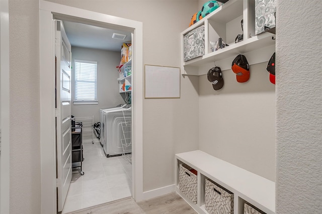 mudroom with light hardwood / wood-style floors and washer and dryer