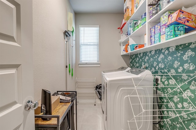 washroom with light tile patterned flooring and washing machine and clothes dryer