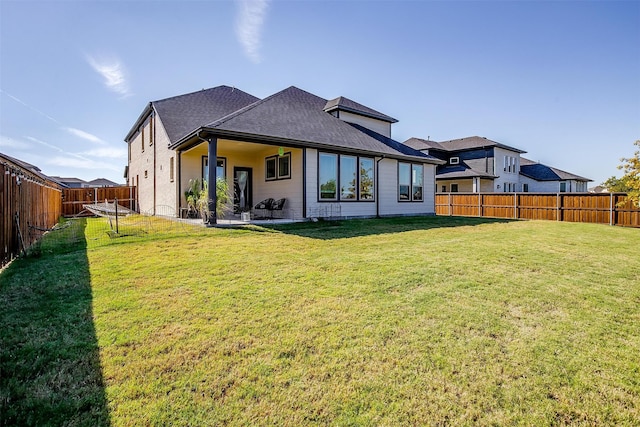 back of house featuring a yard