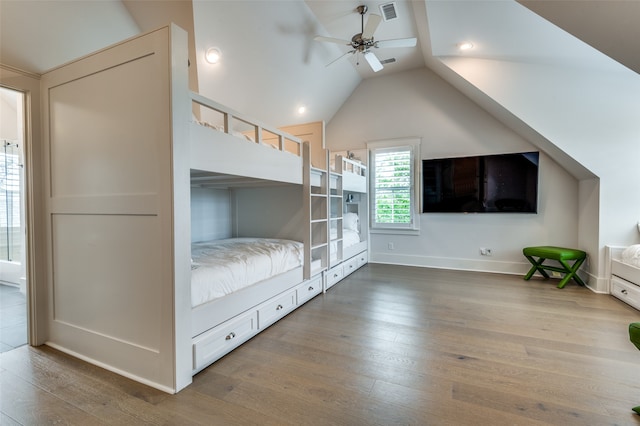 unfurnished bedroom featuring lofted ceiling, wood-type flooring, and ceiling fan