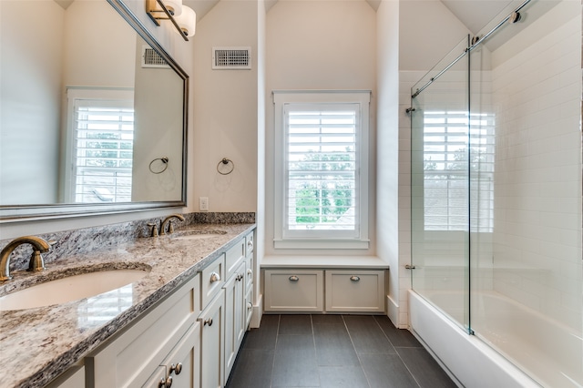 bathroom with vanity and bath / shower combo with glass door