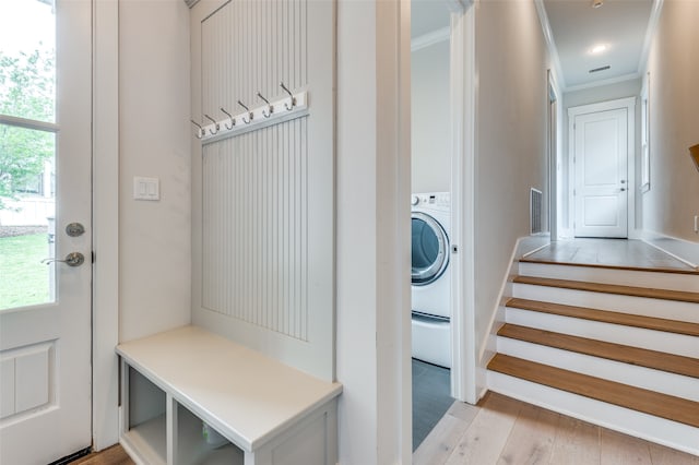 laundry room with washer / dryer, ornamental molding, and light hardwood / wood-style flooring