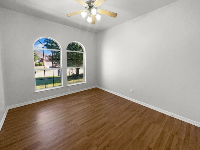 unfurnished room featuring dark hardwood / wood-style floors and ceiling fan