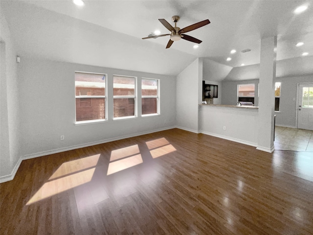 unfurnished living room with ceiling fan, vaulted ceiling, and dark hardwood / wood-style flooring