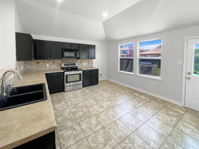 kitchen featuring electric range, black microwave, tasteful backsplash, a sink, and dark cabinetry