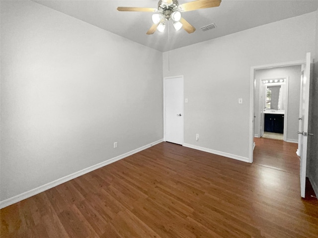 unfurnished room featuring visible vents, baseboards, ceiling fan, and wood finished floors