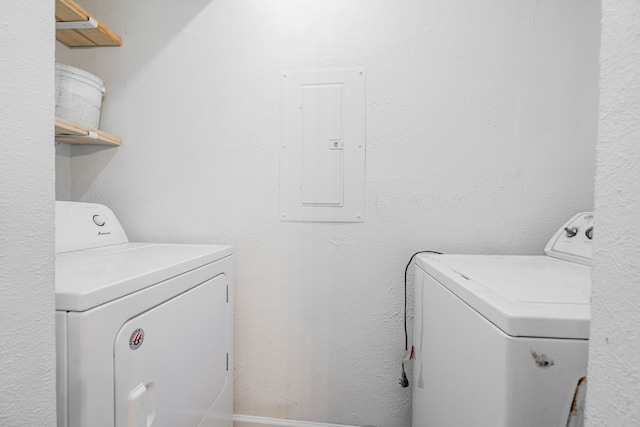 laundry room with washer and dryer and electric panel