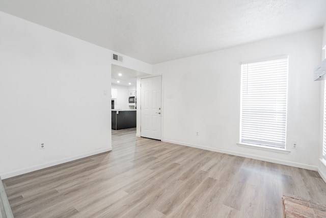 spare room with light wood-type flooring