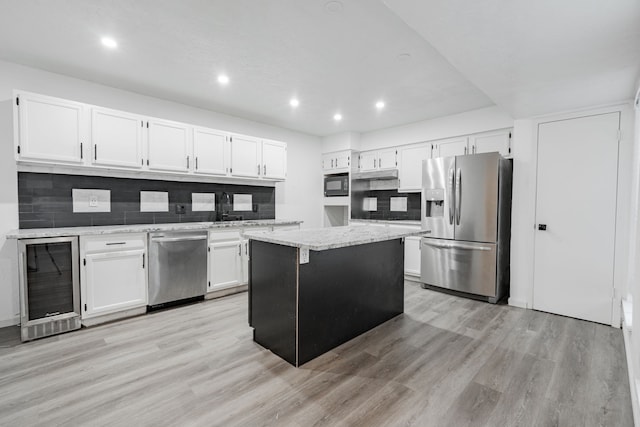 kitchen featuring white cabinetry, wine cooler, appliances with stainless steel finishes, and a kitchen island