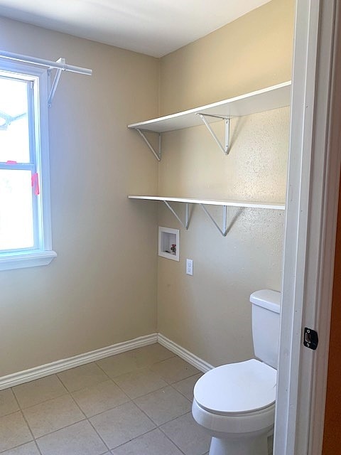 bathroom with tile patterned floors and toilet