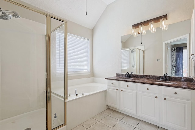 bathroom with tile patterned floors, a textured ceiling, lofted ceiling, vanity, and shower with separate bathtub