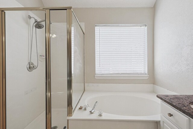 bathroom featuring shower with separate bathtub, vanity, and a healthy amount of sunlight