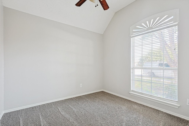 carpeted spare room featuring ceiling fan, lofted ceiling, and a textured ceiling