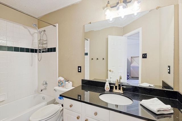 full bathroom featuring a textured ceiling, vanity, toilet, and tiled shower / bath