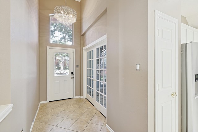 tiled entrance foyer featuring a chandelier