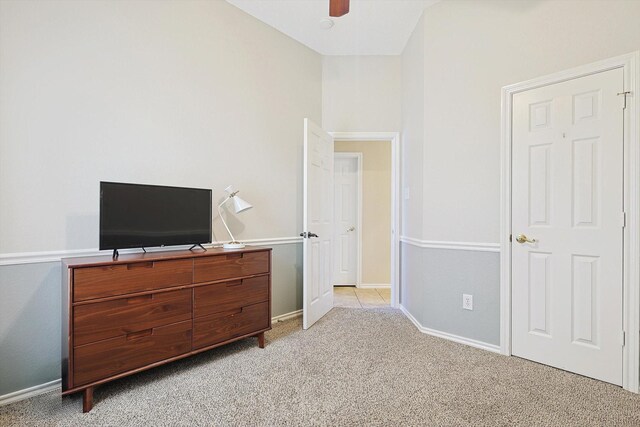 bedroom featuring light carpet and ceiling fan