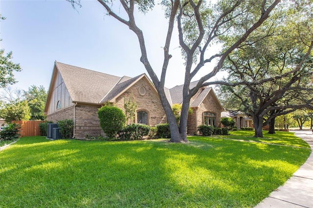 view of front of home featuring a front yard and cooling unit