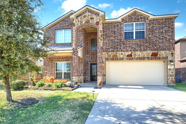 view of property featuring a front lawn and a garage