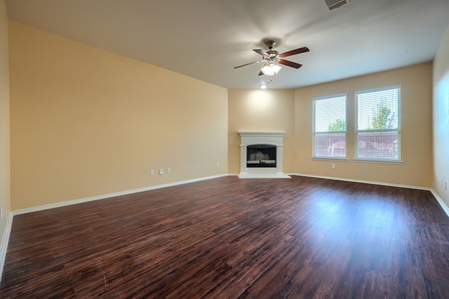 unfurnished living room featuring ceiling fan and dark hardwood / wood-style floors