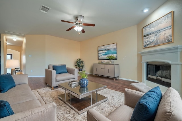 living room featuring wood-type flooring and ceiling fan