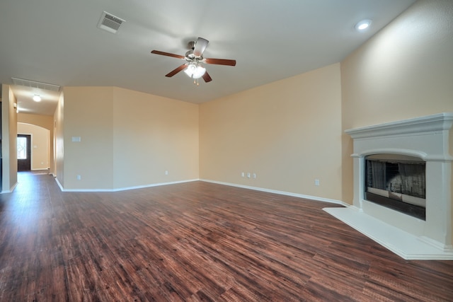 unfurnished living room with dark hardwood / wood-style floors and ceiling fan