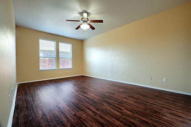 empty room with dark hardwood / wood-style floors and ceiling fan