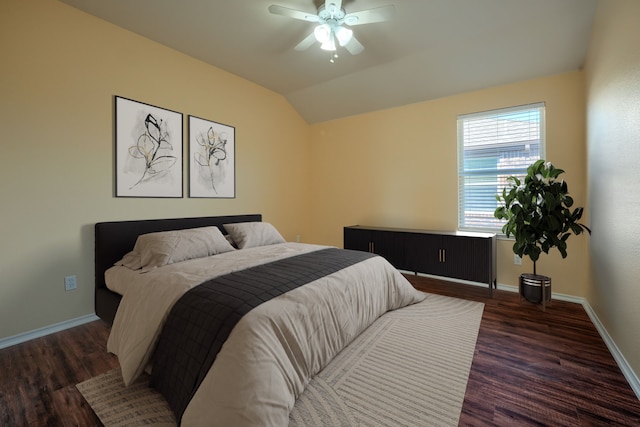 bedroom featuring dark hardwood / wood-style flooring, lofted ceiling, and ceiling fan