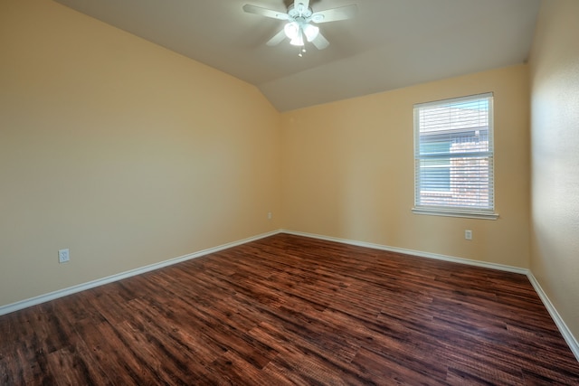 spare room featuring lofted ceiling, dark hardwood / wood-style floors, and ceiling fan