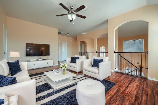 living room featuring lofted ceiling, ceiling fan, and dark hardwood / wood-style flooring