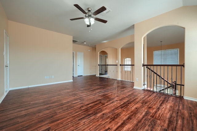 empty room featuring vaulted ceiling, ceiling fan, and dark hardwood / wood-style flooring