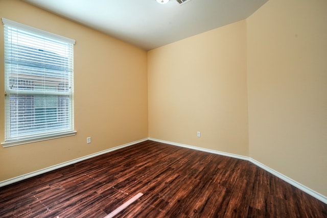 empty room with dark hardwood / wood-style floors