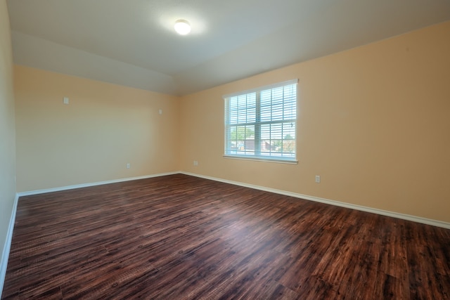 empty room with dark wood-type flooring