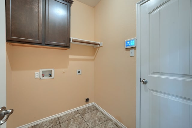 washroom with hookup for a washing machine, light tile patterned flooring, hookup for an electric dryer, hookup for a gas dryer, and cabinets