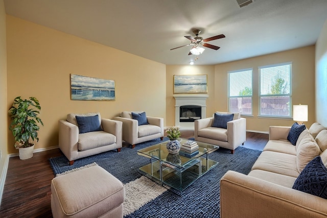 living room featuring ceiling fan and dark hardwood / wood-style flooring