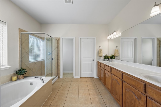 bathroom with plus walk in shower, vanity, and tile patterned flooring