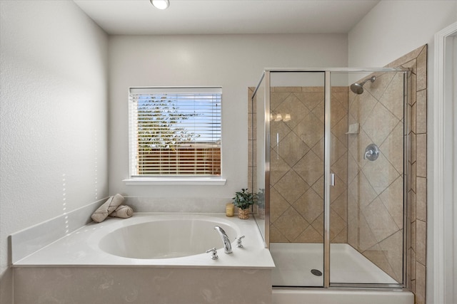 bathroom featuring independent shower and bath