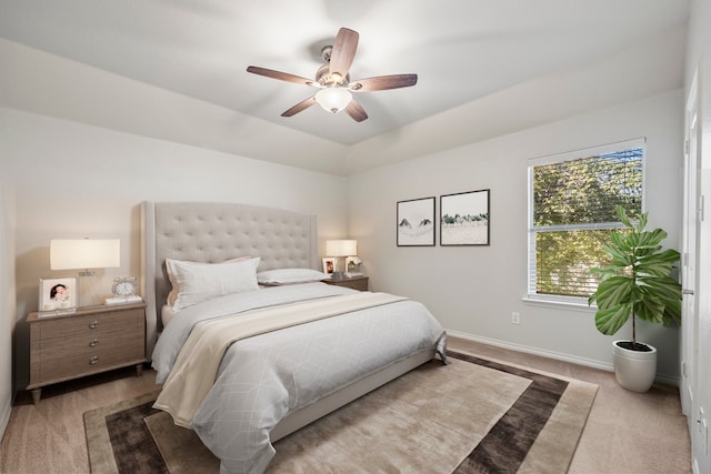 bedroom with ceiling fan and light carpet