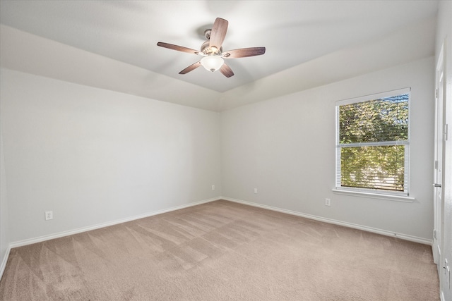 spare room featuring ceiling fan and light colored carpet