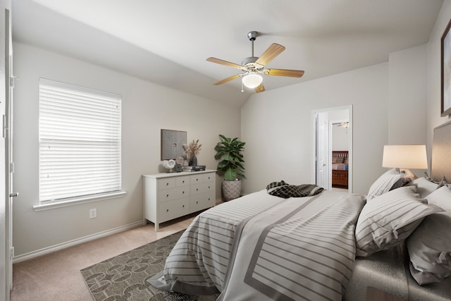 carpeted bedroom featuring connected bathroom, ceiling fan, and vaulted ceiling