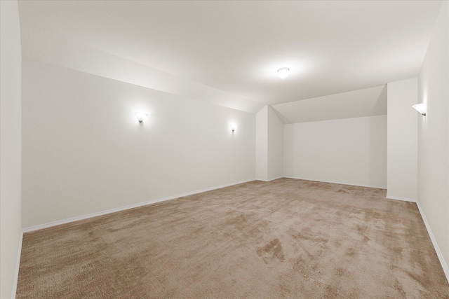 bonus room featuring light colored carpet and vaulted ceiling