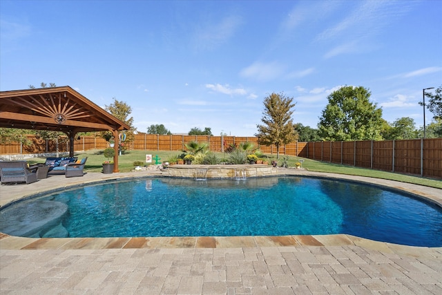 view of pool featuring pool water feature, outdoor lounge area, a yard, and a patio