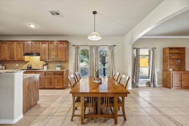 dining space with plenty of natural light and light tile patterned floors