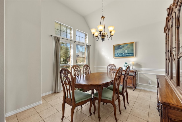 dining space with vaulted ceiling, a notable chandelier, and light tile patterned flooring