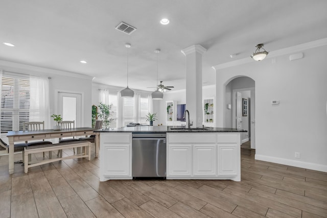 kitchen featuring dishwasher, light wood-type flooring, and an island with sink