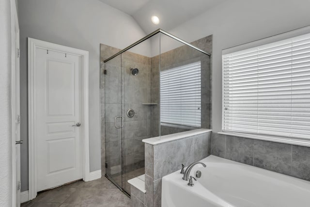 bathroom featuring tile patterned floors, a wealth of natural light, lofted ceiling, and shower with separate bathtub