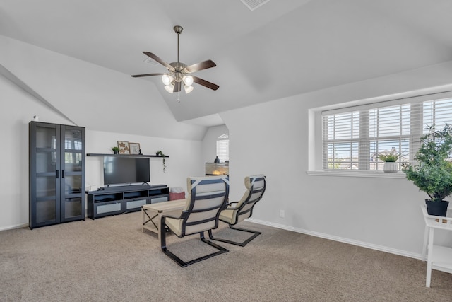 living area with carpet floors, ceiling fan, and lofted ceiling